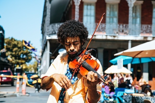 person playing on violin on the street