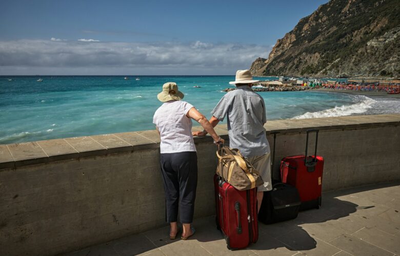 man-and-woman-standing-beside-concrete-seawall-looking-at-beach