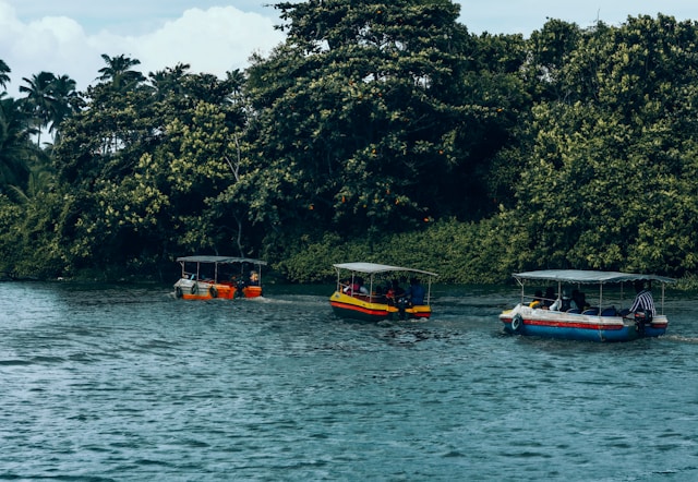 a-group-of-boats-floating-on-top-of-a-river