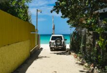 black-car-parked-beside-yellow-building