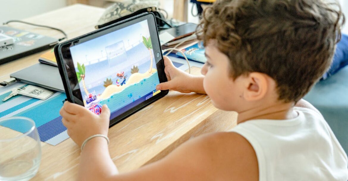 a-boy-in-white-tank-top-playing-on-a-tablet