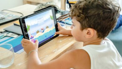 a-boy-in-white-tank-top-playing-on-a-tablet