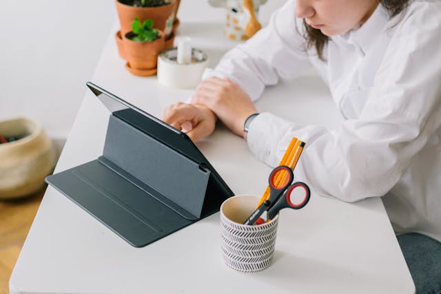 a-person-using-digital-table-on-the-table