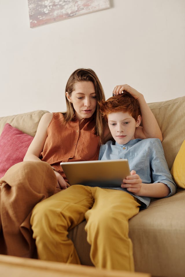 photo-of-woman-and-boy-watching-through-tablet-computer